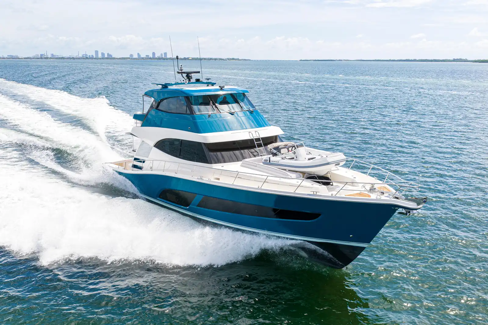 A Riviera 72 Sports Motor Yacht running at speed on open water