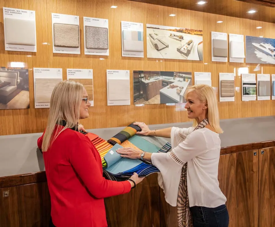 Two women comparing fabric samples in Riviera's interior design studio